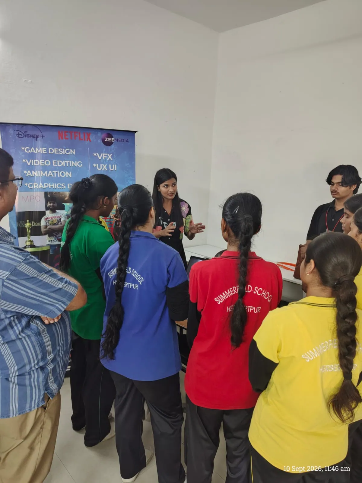 Students exploring creative, animation, and digital media career booth