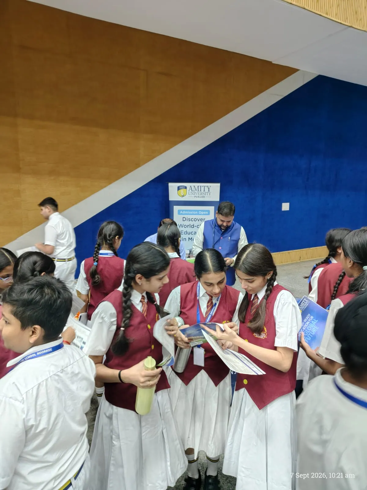 High school students reviewing and discussing university brochures