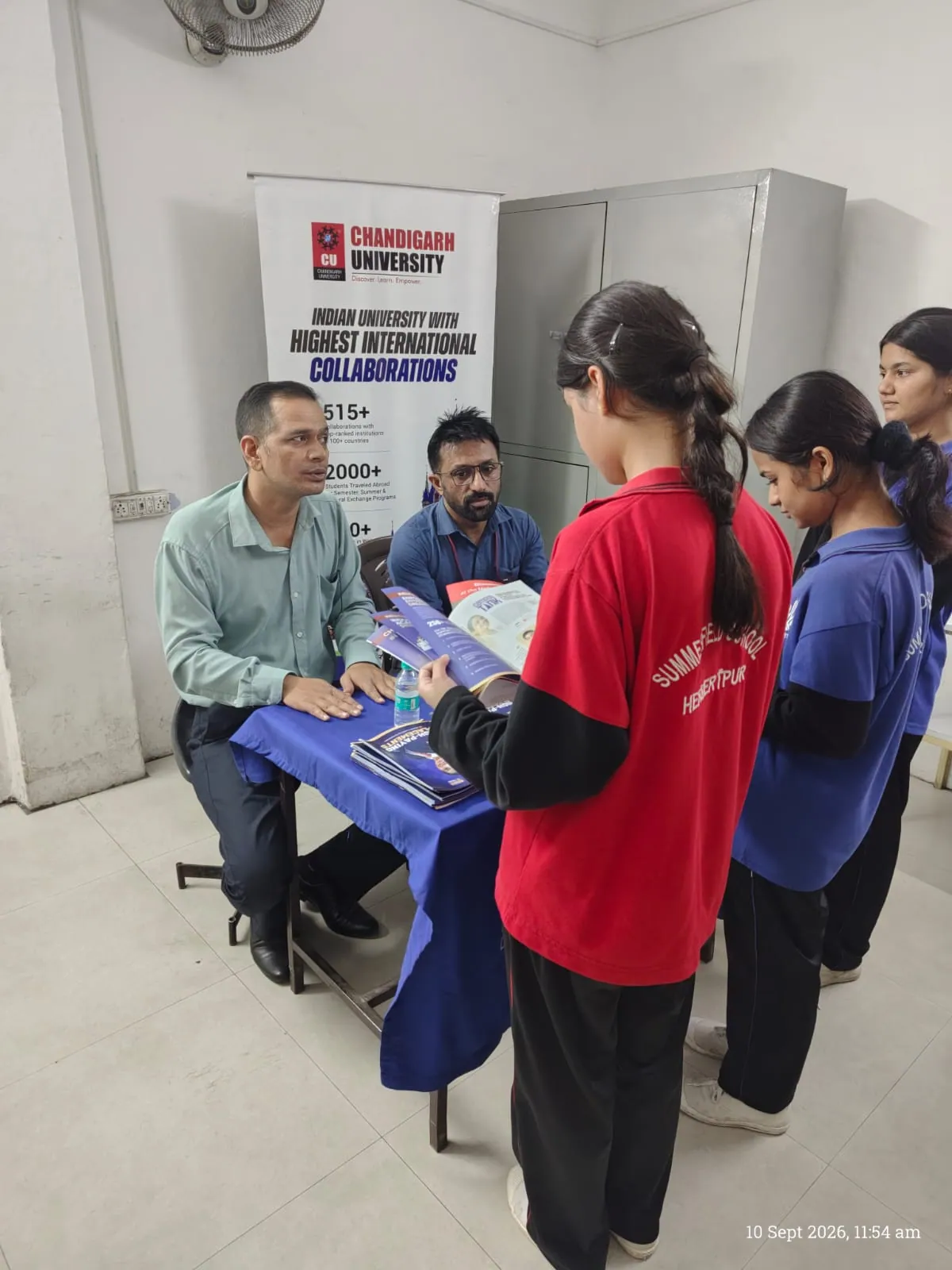 Students reviewing course offerings at university collaborations desk