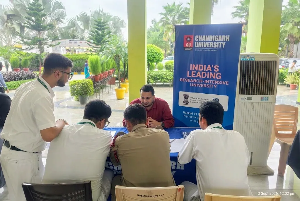 Career counsellor guiding student and parent around an advisory table